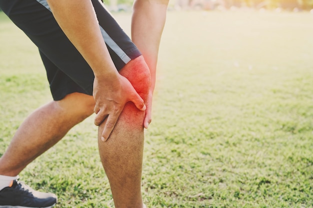 runner sport with running knee injury at park