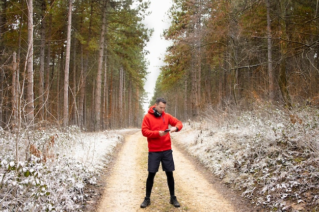 Runner using a running app in the wilderness