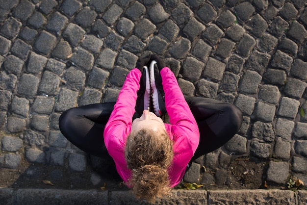 runner   woman warming up and stretching before morning jogging