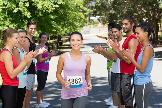 Runners applauding a racer in the park