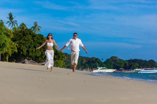 Running couple on a tropical beach