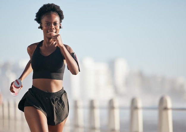 Premium Photo | Running happy and black woman outdoor with music ...