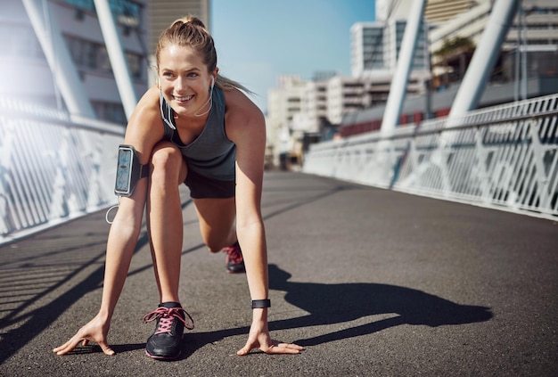 Running is all about endurance Shot of a sporty young woman getting set for a run