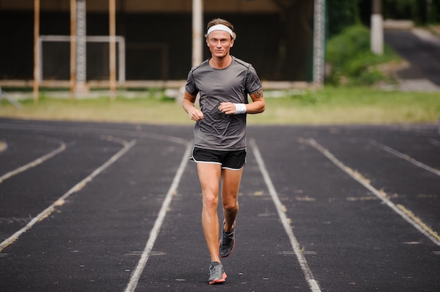 Running man runner sprinting for fitness and health.