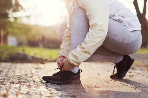 Running shoes runner woman tying laces