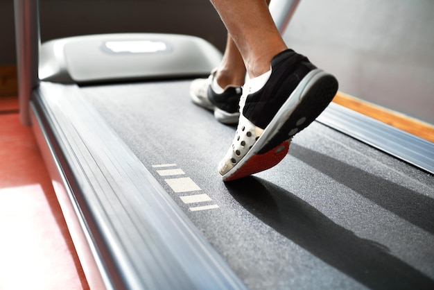 Running to stay fit Closeup shot of a man on a treadmill at the gym