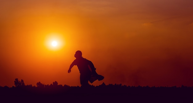 Running superhero silhouette moving forward with determination running and exercise concept of a boy who is a superhero