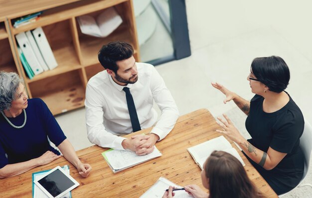 Running through some important pointers High angle shot of a group of businesspeople having a meeting in an office