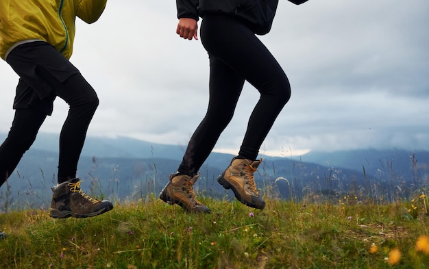 Running together Couple doing fitness Majestic Carpathian Mountains Beautiful landscape of untouched nature