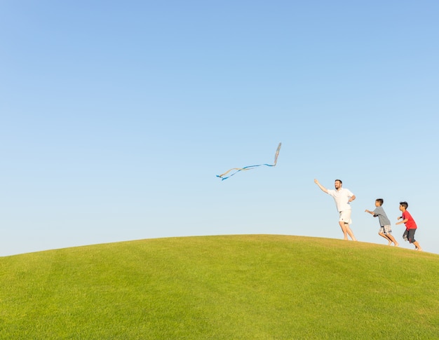 Running with kite on summer holiday vacation, perfect meadow and sky on seaside