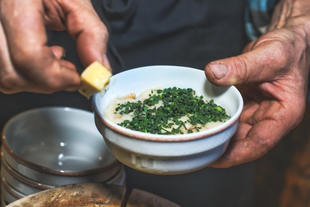 Rural dish of bread and water with cheese and chives