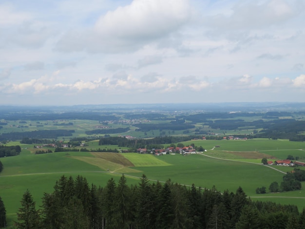 Rural houses surrounded by agricultural fields under a cloudy sky