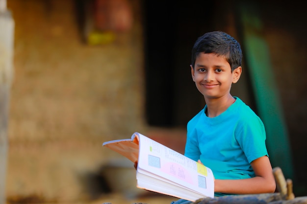 rural indian boy studying at home