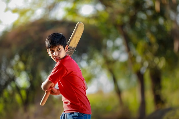Rural Indian Child Playing Cricket