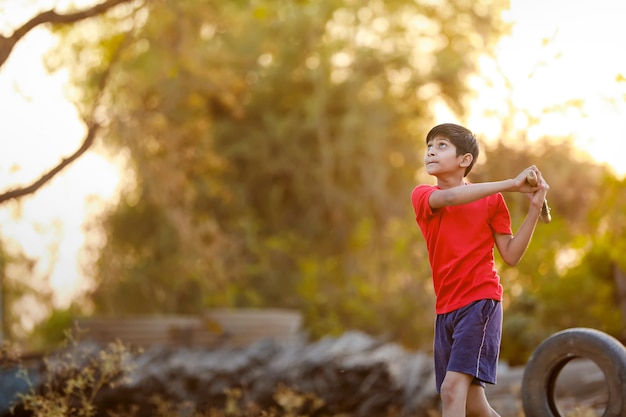 Rural Indian Child Playing Cricket