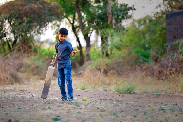 Rural Indian Child Playing Cricket