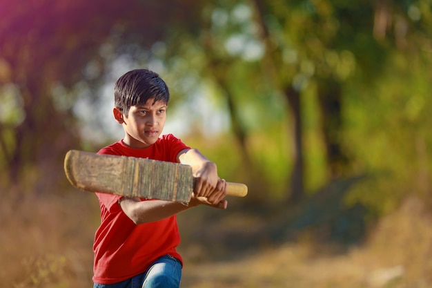 Rural Indian Child Playing Cricket