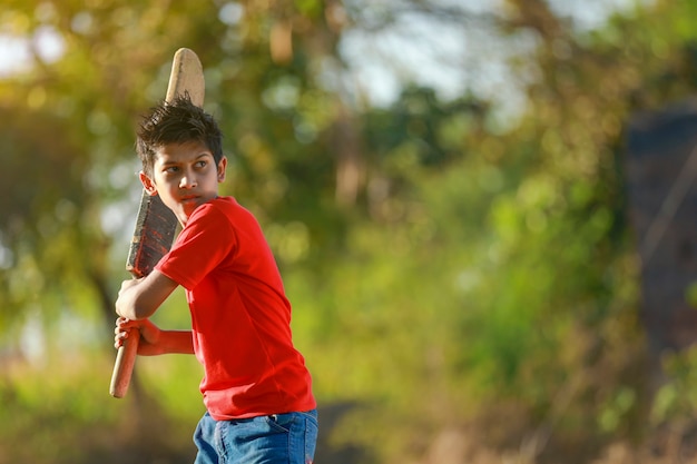 Rural Indian Child Playing Cricket