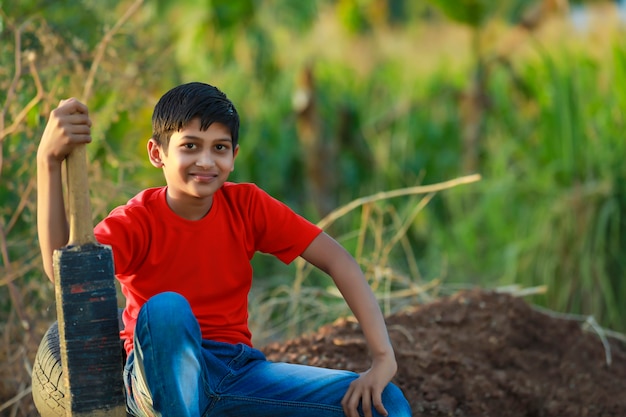 Rural Indian Child Playing Cricket