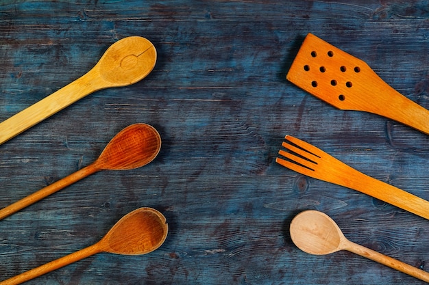 Rural kitchen utensils on vintage wooden background