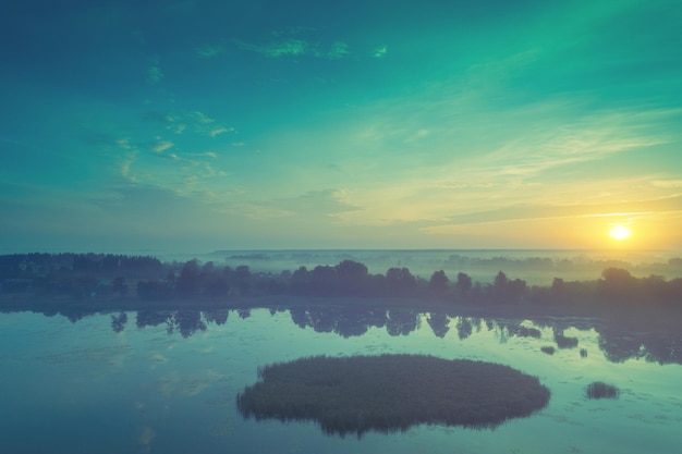 Rural landscape Misty morning Sunrise over lake