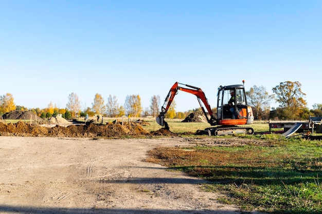 Rural landscape with a tractor earth movers in field