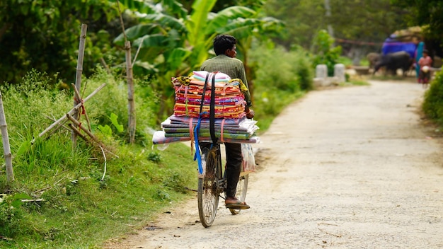 Rural man selling some items from cycle