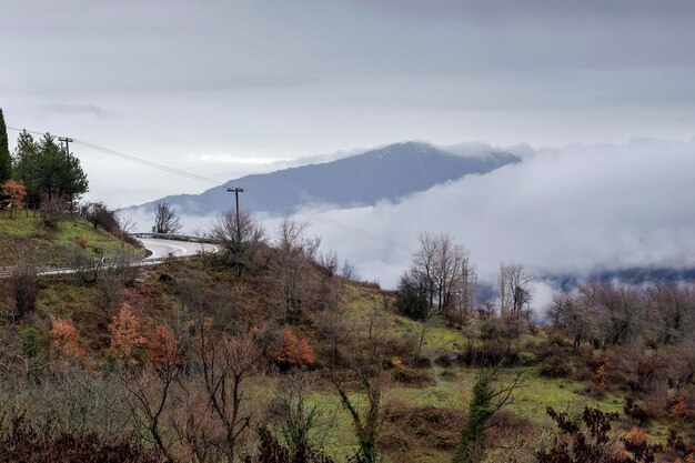 Rural road in the mountains in the winter foggy day Greece region of Thessaly