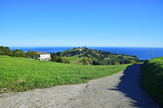 Rural road through the village along the ocean coast The Northern Way of St James Spain