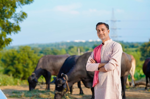 Rural scene Indian farmer standing his dairy farm