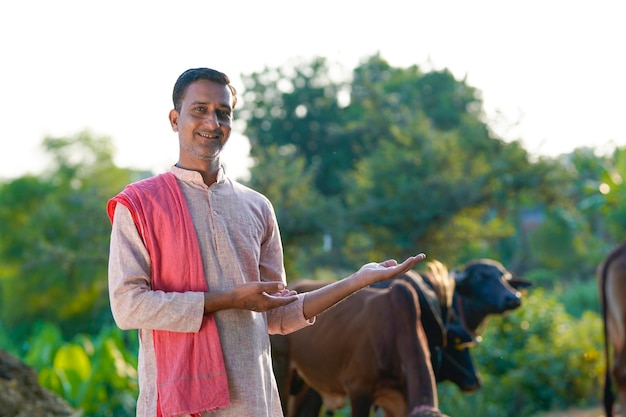 Rural scene Indian farmer standing his dairy farm