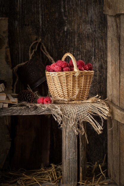 Rural still life with raspberries on rustic table