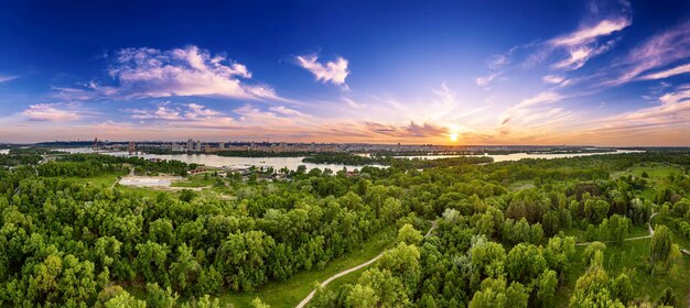 Rural summer sunset in Kiev with Dnipro river and dramatic colorful sky natural background aerial view Amazing seasonal landscape panorama