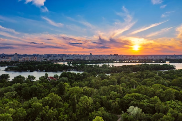 Rural summer sunset in Kiev with Dnipro river and dramatic colorful sky, natural background, aerial view. Amazing seasonal landscape