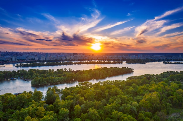 Rural summer sunset in Kiev with Dnipro river and dramatic colorful sky, natural background, aerial view. Amazing seasonal landscape