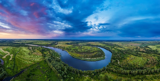 Rural summer sunset landscape with river and dramatic colorful sky natural background aerial panoramic view