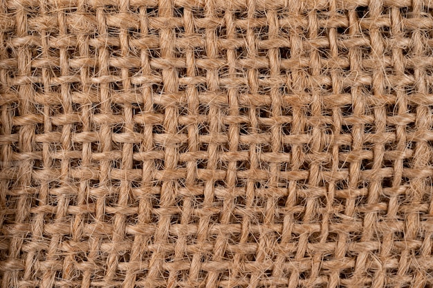 Trama rurale di tela di sacco. fondo di tessuto molto grossolano e ruvido fatto di lino, iuta o canapa