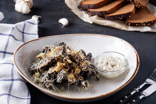 Rusks with cheese and garlic on a plate. Crispy bread with garlic and cheese. Closeup