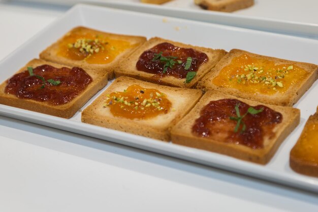 Photo rusks with various jams served on a white plate