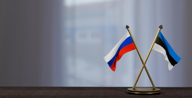 Флаги России и Эстонии на столе Переговоры между Эстонией и Россией на небольшом размытом фоне 3D-работа и 3D-изображение