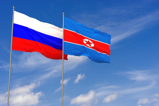 Russia and North Korea flags over blue sky background. 3D illustration