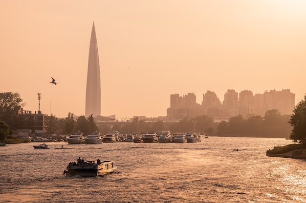 Russia, St.Peterburg. View of the Gazprom tower, anchorage of yachts and boats at the mouth of the Neva River during sunset.