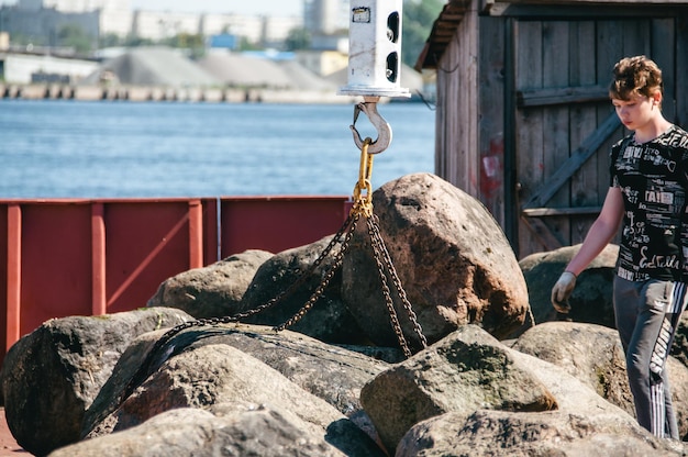 Russia St Petersburg June 2022 River worker sailor on the deck of the ship