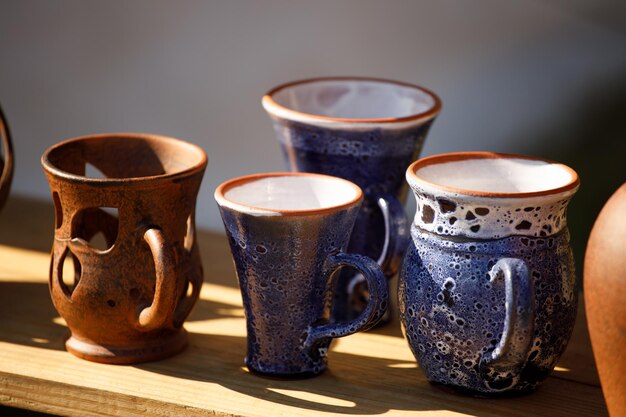 Russia. Vyborg. 20/08/2020 clay mugs are on a wooden shelf. at the festival of the knights