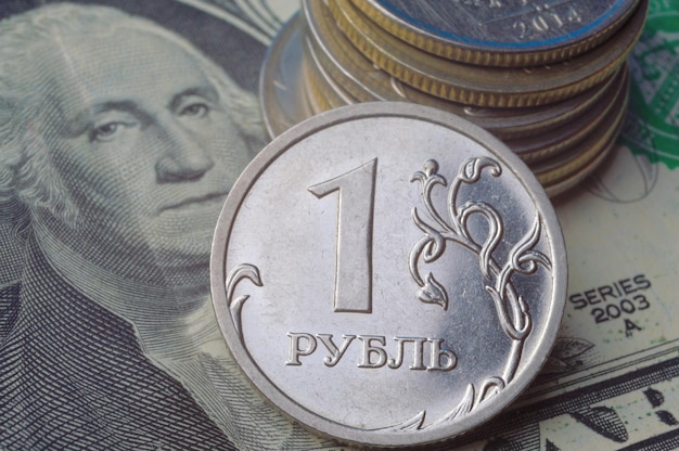 Russian 1 ruble coins lie on an American 1 dollar banknote