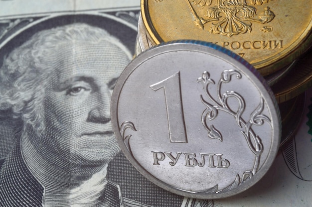 Russian 1 ruble coins lie on an American 1 dollar banknote