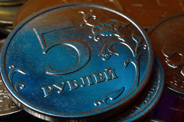 Photo russian 5 ruble coin is highlighted in blue and red. close-up.