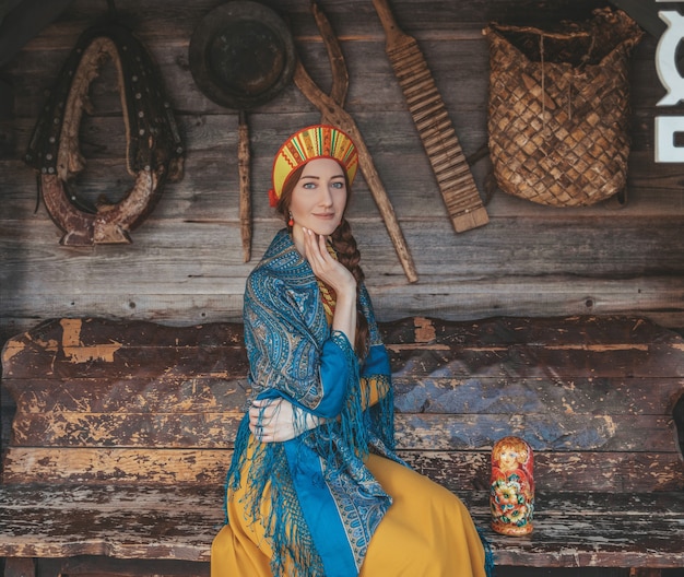 Photo russian beauty closeup on the traditional background with different things for life.