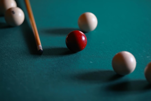 Russian billiard balls cue triangle chalk on a table green\
cloth copy space