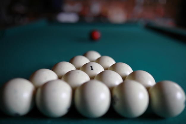 Russian billiard balls cue triangle chalk on a table Green cloth Copy space